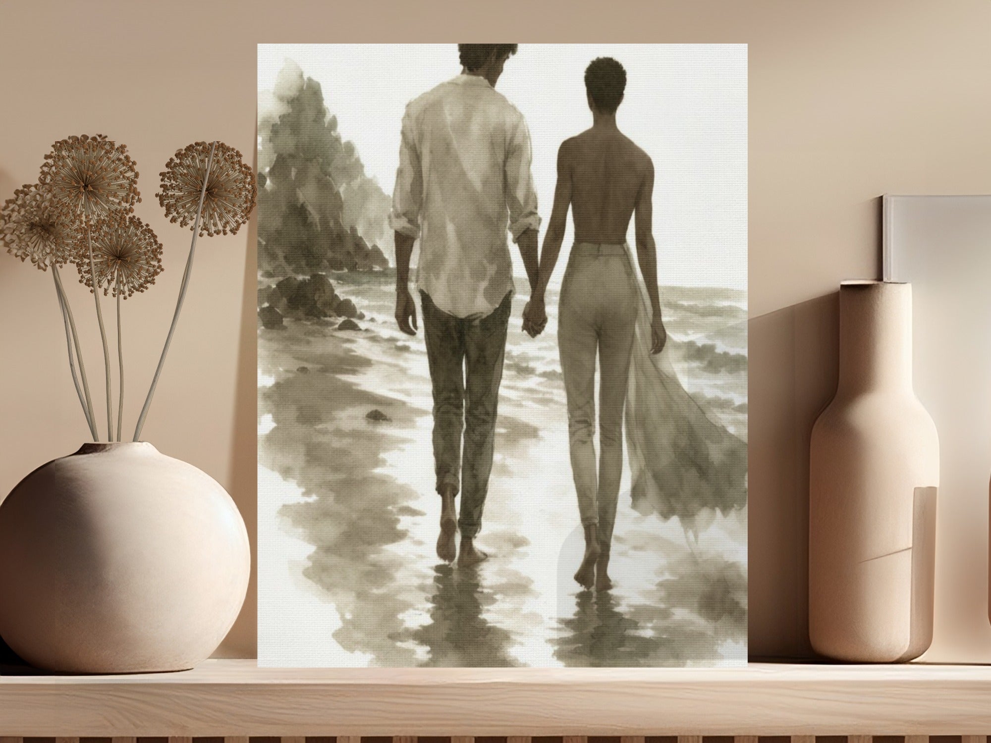 Couple holding hands walking on beach with ocean and cliffs.