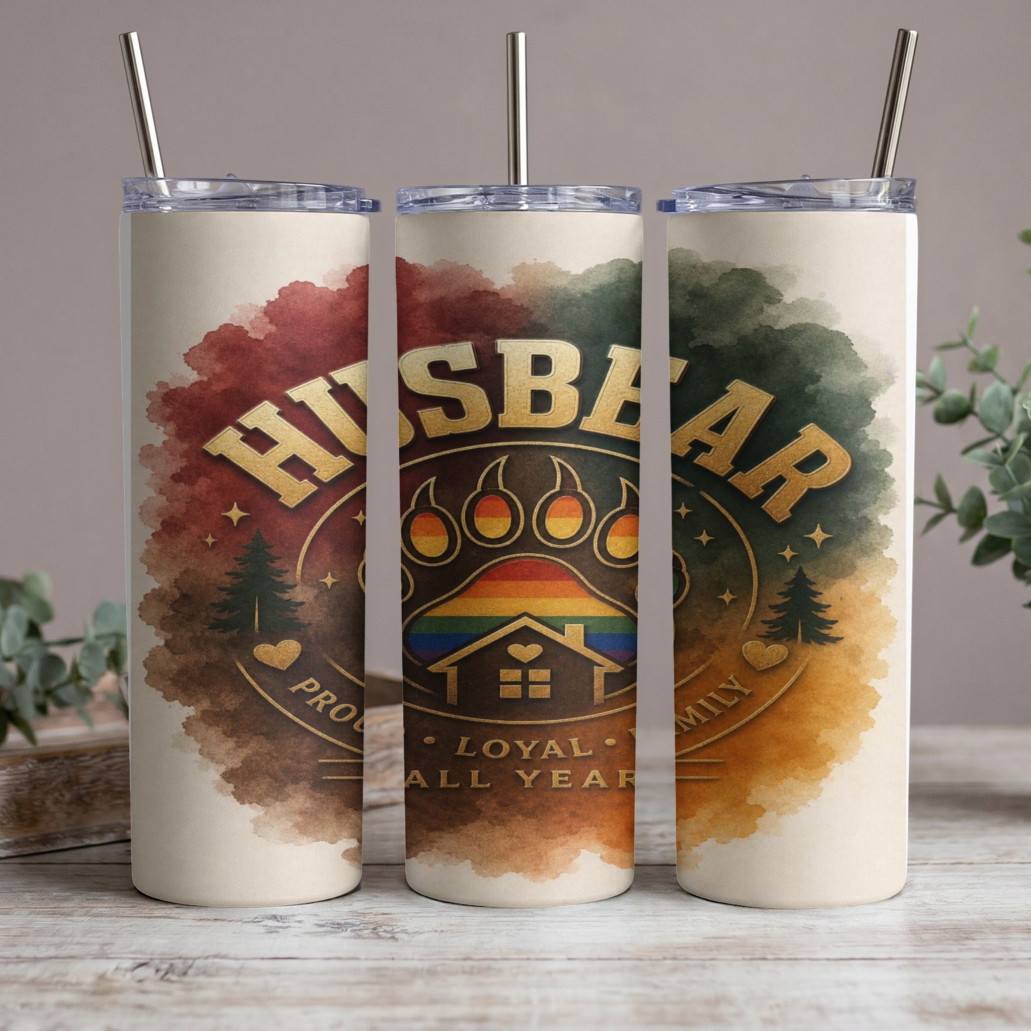 Tumbler with "Husbear" text, paw print, rainbow house, and pine trees.