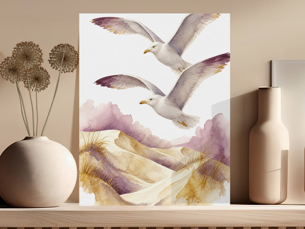 Watercolor painting of two seagulls flying over sand dunes with purple accents.