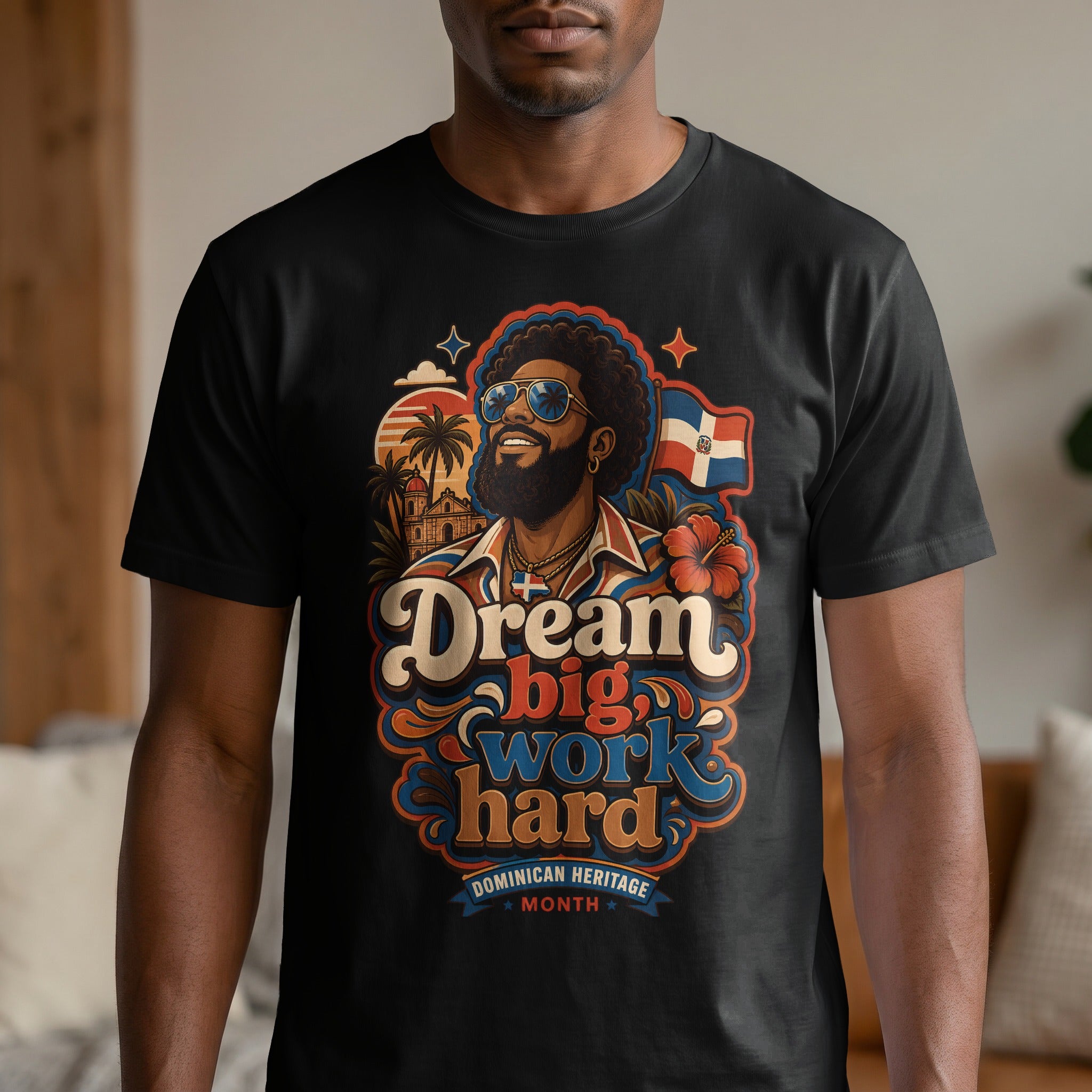 Man wearing black t-shirt with "Dream big work hard Dominican Heritage Month" text and imagery.