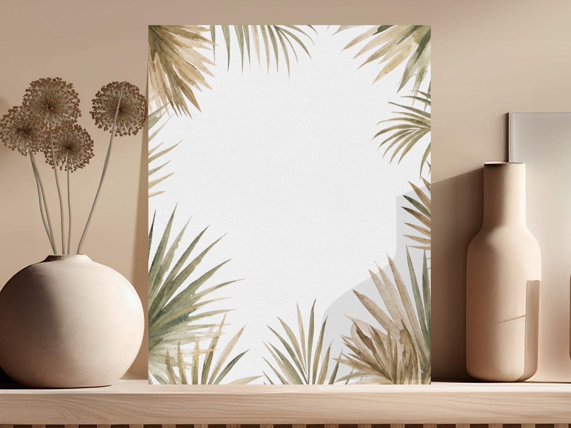 Blank canvas with a palm leaf border, displayed with dried flowers and a vase.