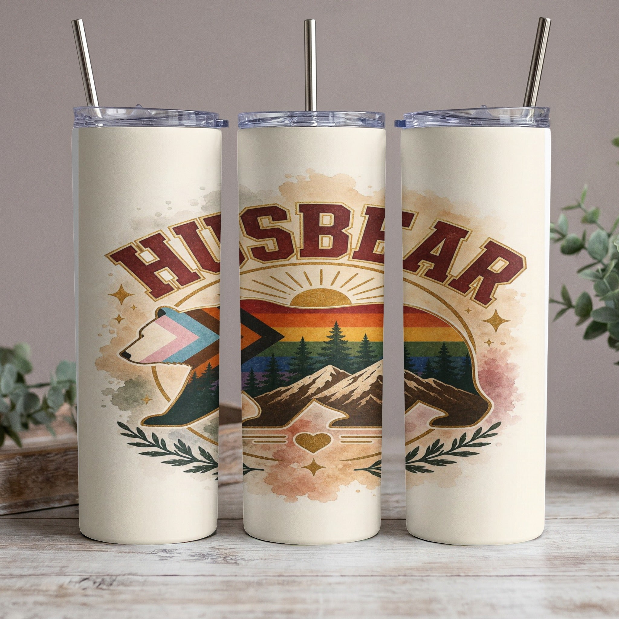 Cream tumbler with "Husbear" text and a bear graphic with mountain and rainbow landscape.