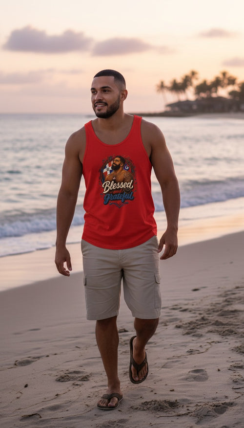 Oso Caribeño red tank top with Blessed and Grateful Dominican heritage graphic worn by a man on a beach at sunset.